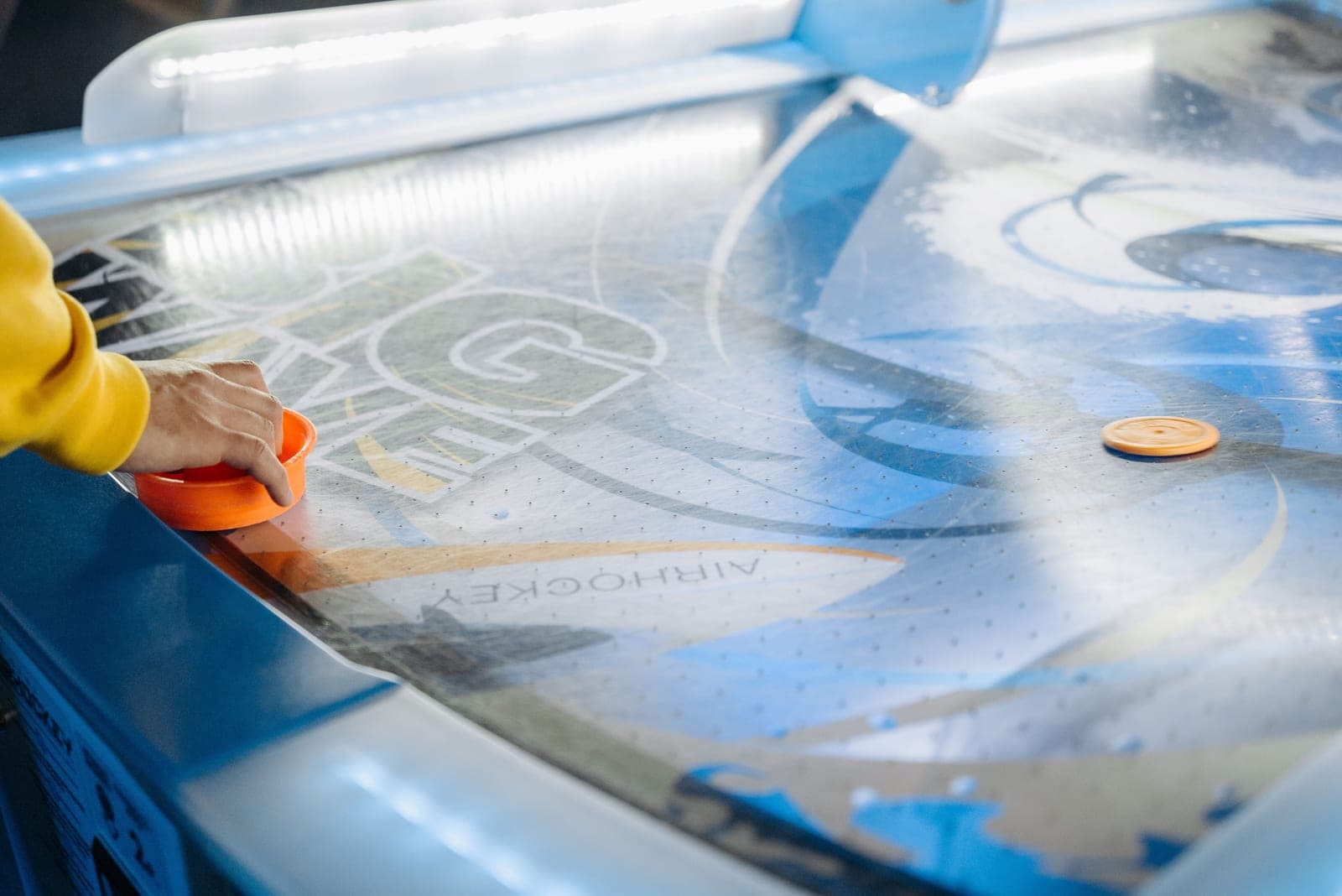 A multi-game table with interchangeable play surfaces
