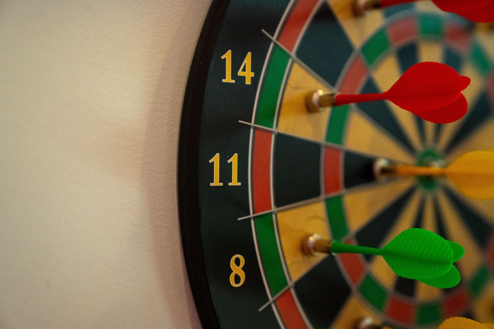 A bristle dart board with thin wiring photographed close up on a dark wall