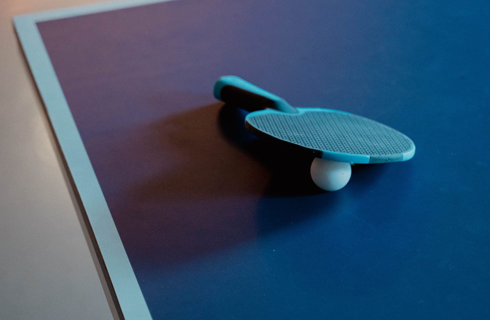 A sectioned table tennis conversion top partly assembled over a billiard table