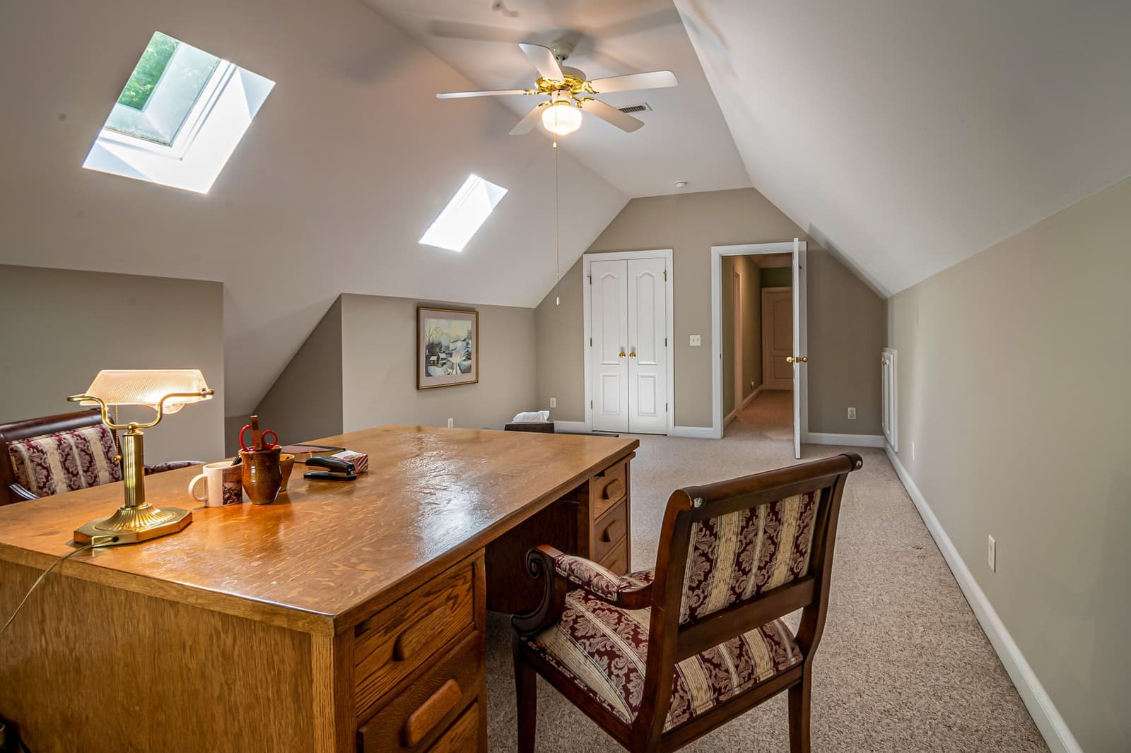 A bonus room with a sloped ceiling and a knee wall along one side