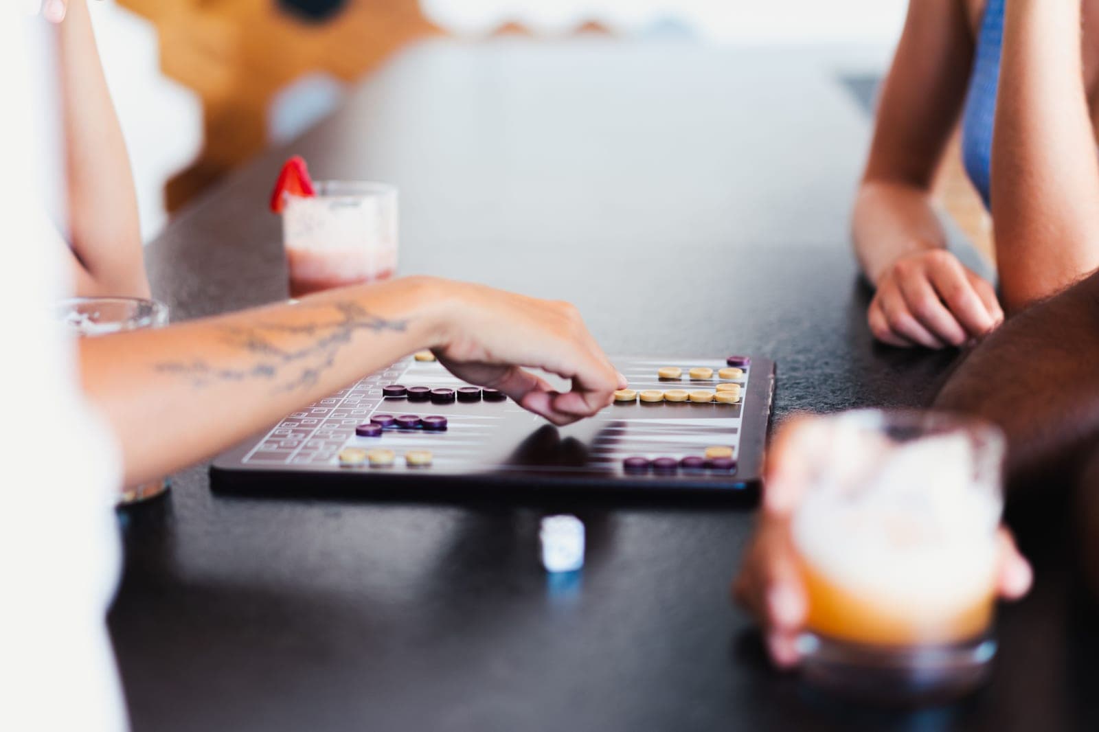 A shuffleboard table with a built-in scorer at the end of the cabinet